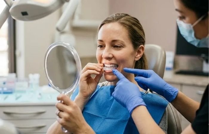 Teaching patient how to place her bleaching trays for much whiter teeth
